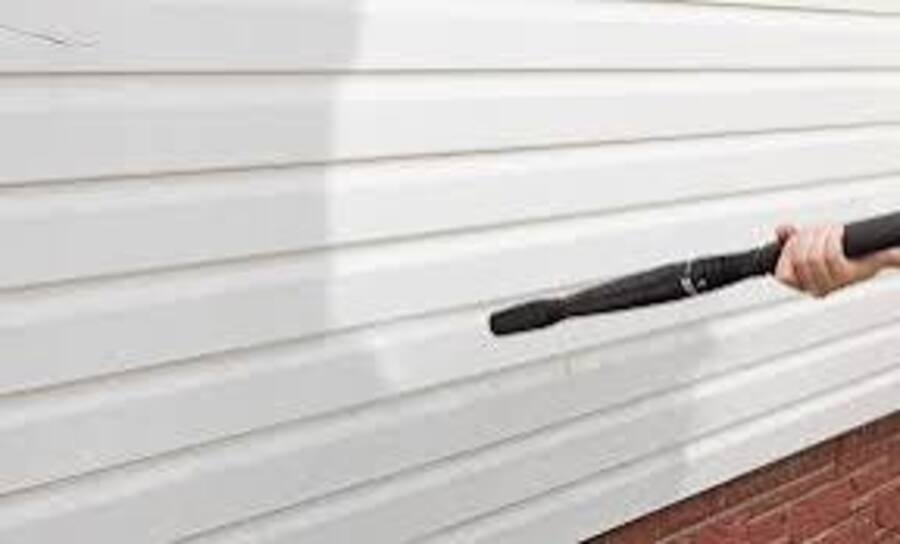 Summit Spray . Co Pressure Washing a wall.